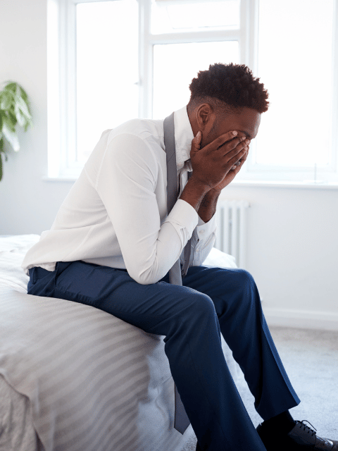 stressed out man sitting on bed